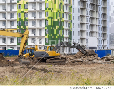 Excavator digs the ground for the foundation Excavator digs the ground for the foundation 68252768