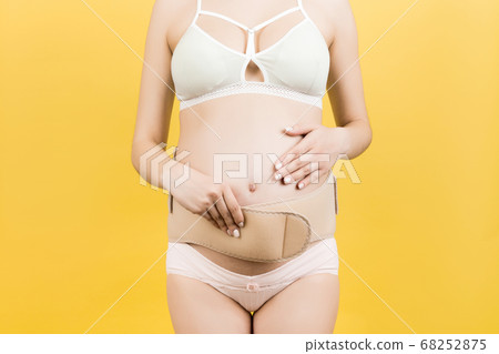 Cropped image of pregnant woman in underwear Cropped image of pregnant woman in underwear 68252875