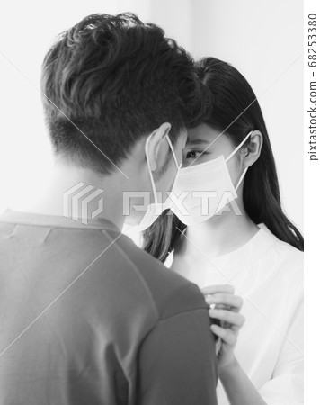 Young asian woman and man wearing Surgical mask at home in black and white 68253380