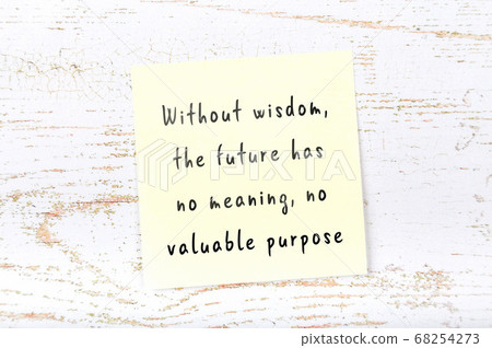 Yellow sticky note on wooden wall with wise quote 68254273