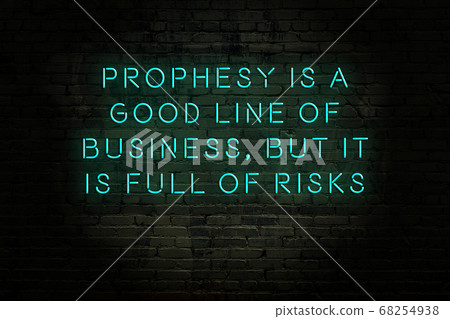 Wise quote. Neon inscription against brick wall Wise quote. Neon inscription against brick wall 68254938