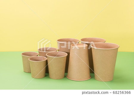 Paper disposable tableware on yellow and green Paper disposable tableware on yellow and green 68256366