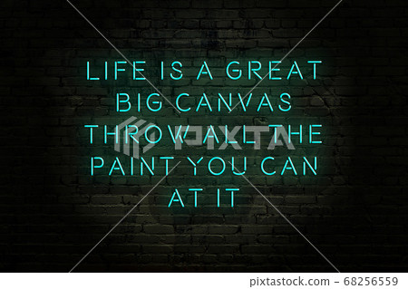 Wise quote. Neon inscription against brick wall 68256559