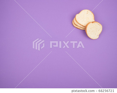Sliced white bread on a purple background. 68256721
