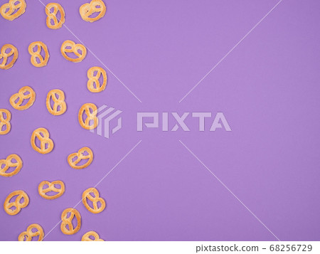 Sweet pretzel on a purple background. Sweet pretzel on a purple background. 68256729