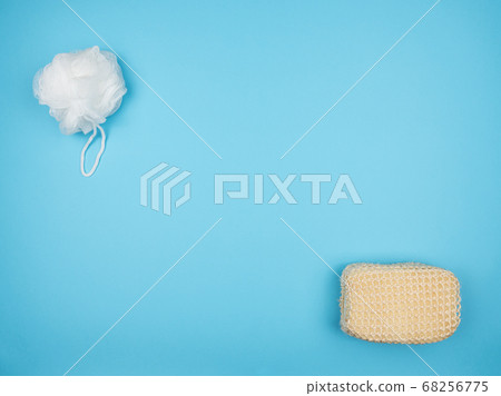 Two washcloths for bathing on a blue background. Two washcloths for bathing on a blue background. 68256775