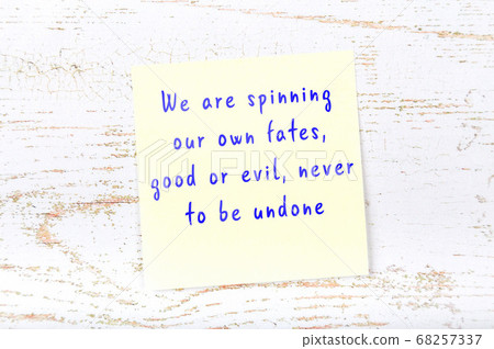 Wise quote on sticky note on wooden wall  68257337