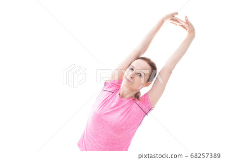 Smiling young woman doing stretching 68257389