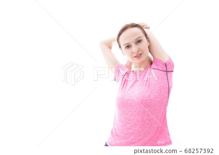 Smiling young woman doing stretching 68257392