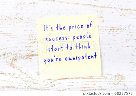 Wise quote on sticky note on wooden wall Wise quote on sticky note on wooden wall 68257573