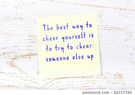 Wise quote on sticky note on wooden wall Wise quote on sticky note on wooden wall 68257586