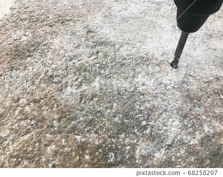 A sturdy, hard metal iron drill bit drills a hole A sturdy, hard metal iron drill bit drills a hole 68258207