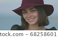 Beautiful girl in a red hat smiles, shows tongue and fooling around 68258601