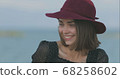 Beautiful girl in a red hat smiles, shows tongue and fooling around 68258602