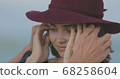 Beautiful girl in a red hat smiles, shows tongue and fooling around 68258604