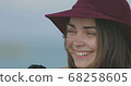 Beautiful girl in a red hat smiles, shows tongue and fooling around 68258605