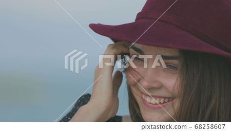 Beautiful girl in a red hat smiles, shows tongue and fooling around Beautiful girl in a red hat smiles, shows tongue and fooling around 68258607