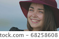 Beautiful girl in a red hat smiles, shows tongue and fooling around 68258608