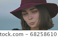Beautiful girl in a red hat smiles, shows tongue and fooling around 68258610