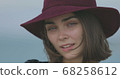 Beautiful girl in a red hat smiles, shows tongue and fooling around 68258612