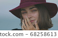 Beautiful girl in a red hat smiles, shows tongue and fooling around 68258613