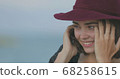 Beautiful girl in a red hat smiles, shows tongue and fooling around 68258615