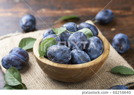 Sweet Plums in a plate on a wooden table. Sweet Plums in a plate on a wooden table. 68258640