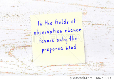 Yellow sticky note on wooden wall with wise quote 68259073