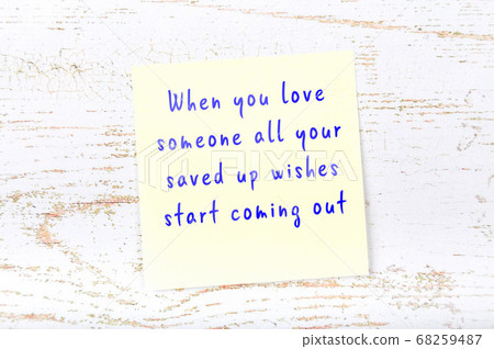 Wise quote on sticky note on wooden wall Wise quote on sticky note on wooden wall 68259487