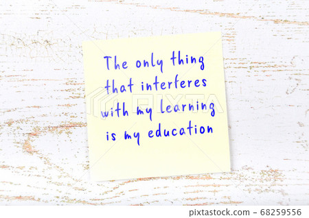 Yellow sticky note on wooden wall with wise quote Yellow sticky note on wooden wall with wise quote 68259556
