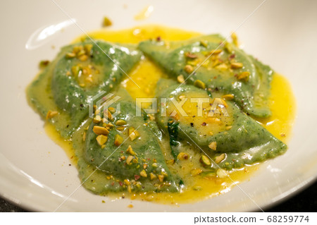 green ravioli with spinach and nuts in a plate green ravioli with spinach and nuts in a plate 68259774