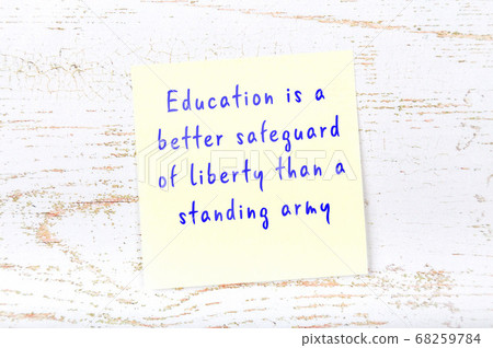 Yellow sticky note on wooden wall with wise quote Yellow sticky note on wooden wall with wise quote 68259784