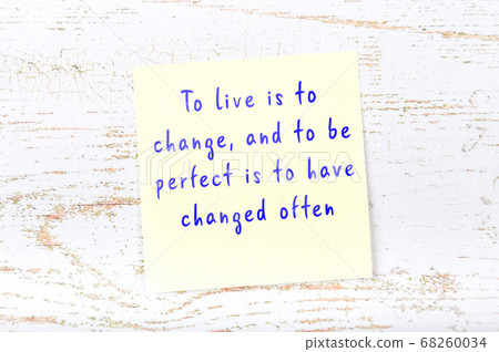 Wise quote on sticky note on wooden wall  68260034