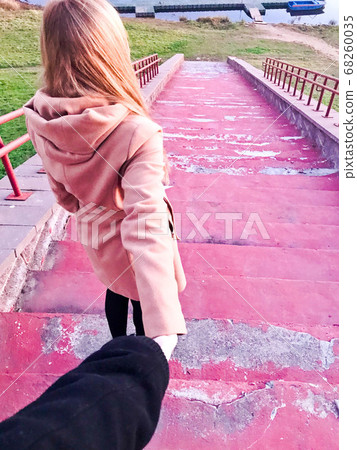A beautiful girl in a brown coat with long blond A beautiful girl in a brown coat with long blond 68260035