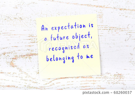 Wise quote on sticky note on wooden wall Wise quote on sticky note on wooden wall 68260037