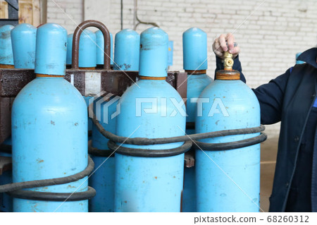 Large iron metal blue gas cylinders with oxygen Large iron metal blue gas cylinders with oxygen 68260312