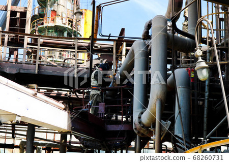 Worker repairman fitter welder repairs a pipeline 68260731