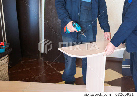 A man worker in work clothes working 68260931