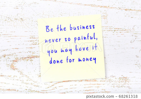 Yellow sticky note on wooden wall with wise quote 68261318