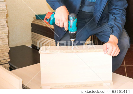 A man worker in work clothes working 68261414