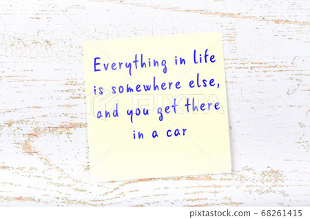 Yellow sticky note on wooden wall with wise quote Yellow sticky note on wooden wall with wise quote 68261415
