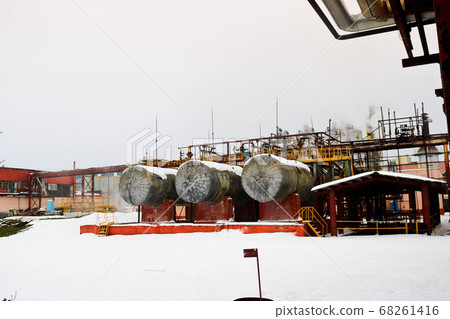 Large iron tanks, ladders and protective fencing 68261416