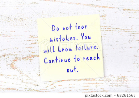 Wise quote on sticky note on wooden wall Wise quote on sticky note on wooden wall 68261565