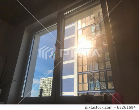A bright light flare ray of sun shines through 68261694