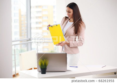 Young pretty business woman with notebook in the office 68261958
