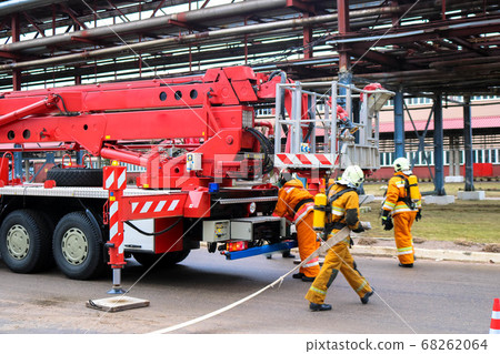 Firemen rescue workers in fireproof suits came Firemen rescue workers in fireproof suits came 68262064