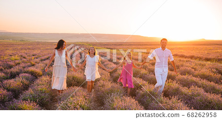 Family in lavender flowers field at sunset 68262958