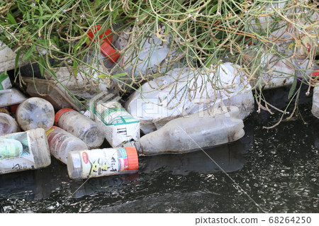 Garbage dumped in the river 68264250