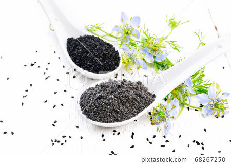 Flour and seeds of kalingi in spoons on board Flour and seeds of kalingi in spoons on board 68267250