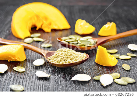 Flour and seeds pumpkin in spoons on board Flour and seeds pumpkin in spoons on board 68267256